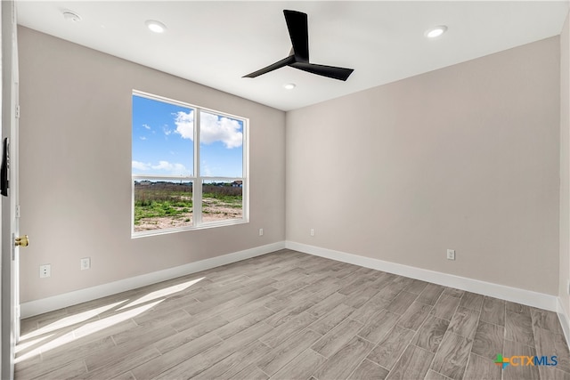 empty room with light wood-type flooring and ceiling fan