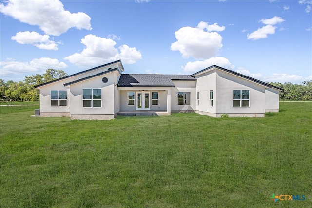 rear view of property with a lawn and french doors