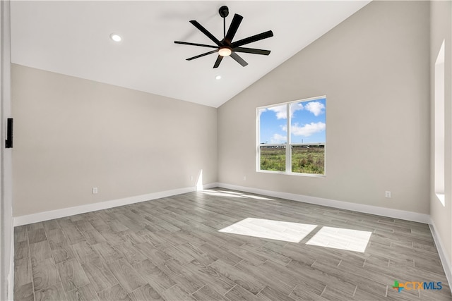 spare room featuring high vaulted ceiling, ceiling fan, and light hardwood / wood-style flooring