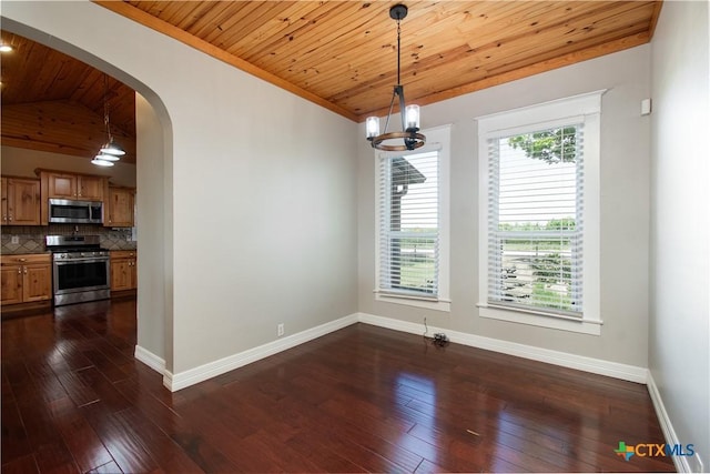 2241 Berger Rd, Temple, TX 76501 - unfurnished dining area featuring baseboards, dark wood-style flooring, arched walkways, plenty of natural light, and wooden ceiling
