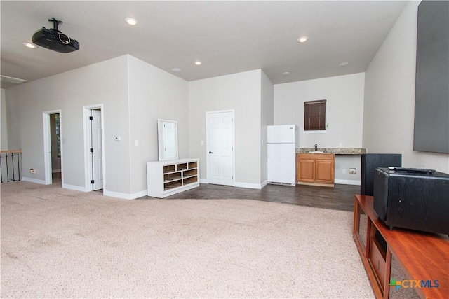 2241 Berger Rd, Temple, TX 76501 - living room featuring dark carpet, baseboards, and recessed lighting