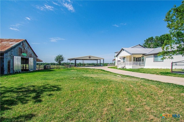 2241 Berger Rd, Temple, TX 76501 - view of yard featuring a detached carport, an outbuilding, and concrete driveway