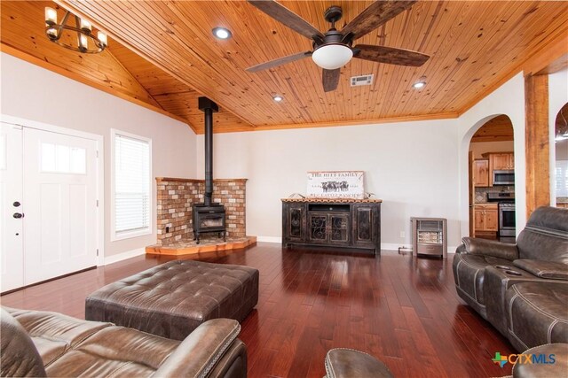 2241 Berger Rd, Temple, TX 76501 - living room with wood ceiling, a wood stove, ceiling fan, baseboards, and arched walkways