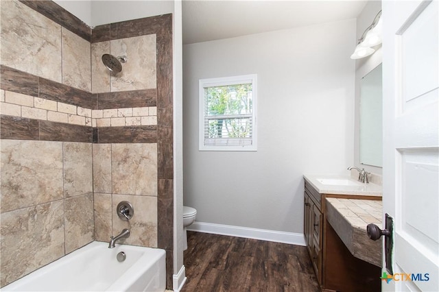 2241 Berger Rd, Temple, TX 76501 - bathroom with toilet, wood finished floors, vanity,  shower combination, and baseboards