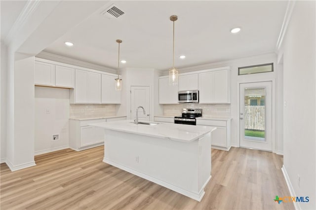 kitchen with sink, white cabinets, stainless steel appliances, and light hardwood / wood-style flooring