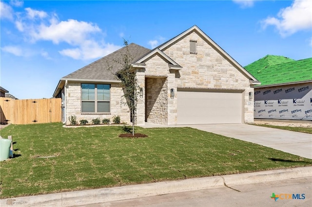 view of front of property with a front lawn and a garage