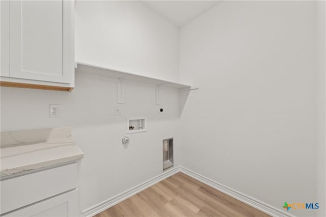 laundry area featuring cabinets, hookup for an electric dryer, gas dryer hookup, hookup for a washing machine, and light hardwood / wood-style floors