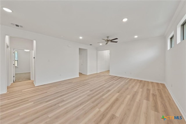 spare room featuring ceiling fan, light hardwood / wood-style floors, and ornamental molding