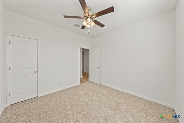 unfurnished bedroom with ceiling fan and light carpet