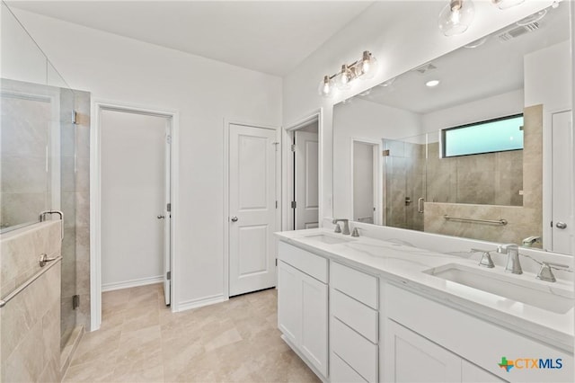 bathroom featuring vanity and a shower with shower door