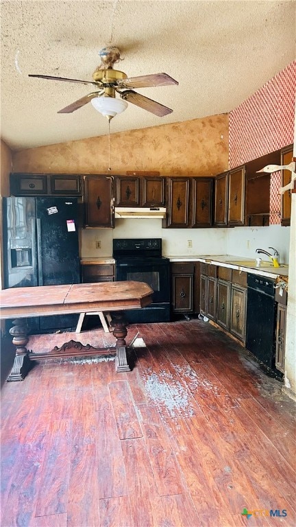 kitchen with black appliances, a textured ceiling, dark brown cabinetry, dark hardwood / wood-style flooring, and lofted ceiling