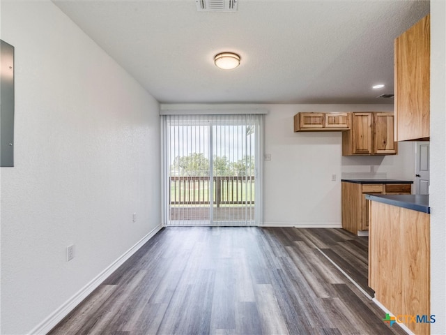 kitchen featuring dark wood-type flooring and a textured ceiling