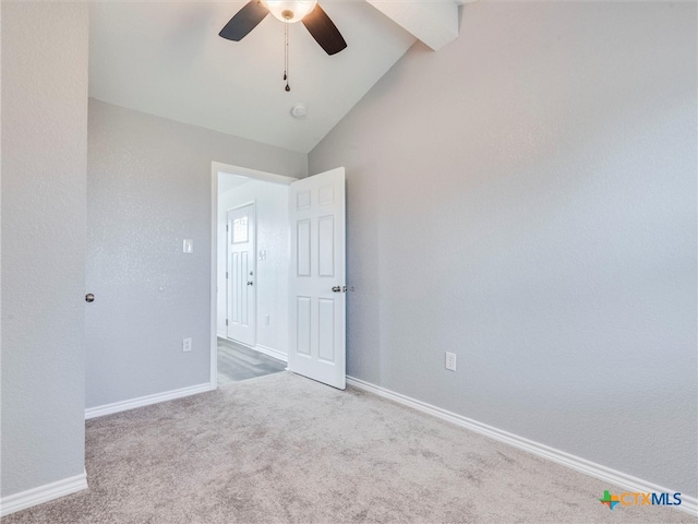 unfurnished bedroom featuring light carpet, vaulted ceiling, and ceiling fan