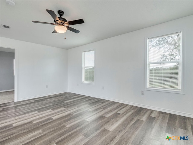 unfurnished room with light hardwood / wood-style floors, plenty of natural light, and ceiling fan