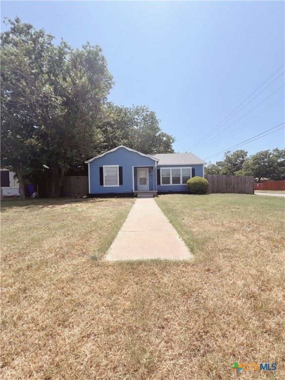 ranch-style home with a front lawn