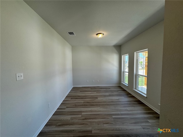 spare room with dark wood-type flooring