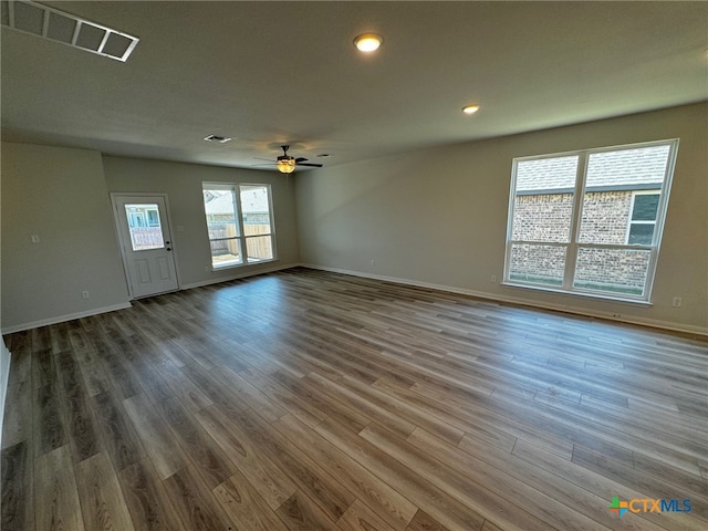 empty room with dark wood-type flooring and ceiling fan