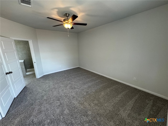 empty room featuring ceiling fan and dark carpet