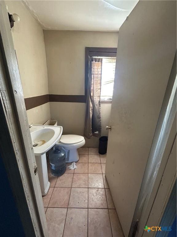 bathroom featuring toilet and tile patterned floors