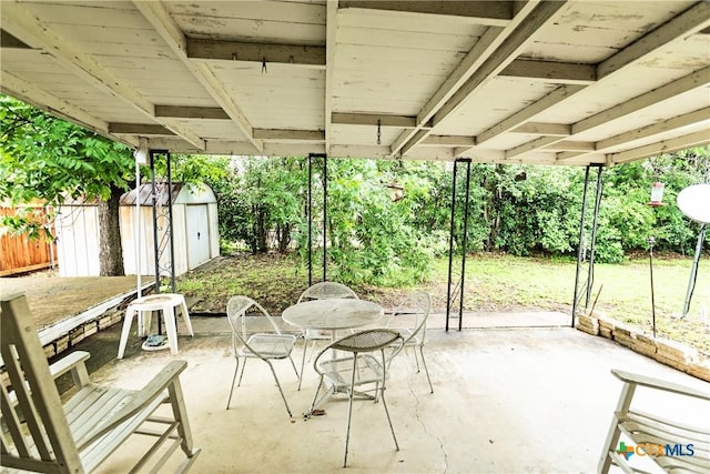 3206 Shady Hill Dr, Temple, TX 76502 - fenced backyard featuring outdoor dining area, a storage unit, and a patio area