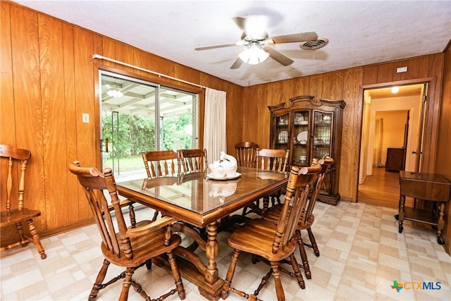 3206 Shady Hill Dr, Temple, TX 76502 - dining area featuring light floors, wood walls, and a ceiling fan