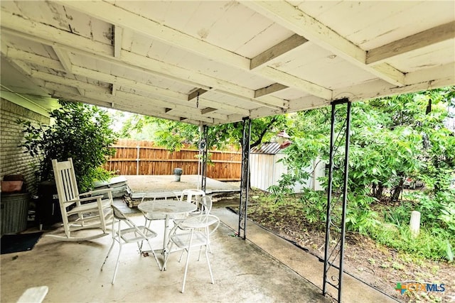 3206 Shady Hill Dr, Temple, TX 76502 - fenced backyard with outdoor dining space, a patio, and a storage unit
