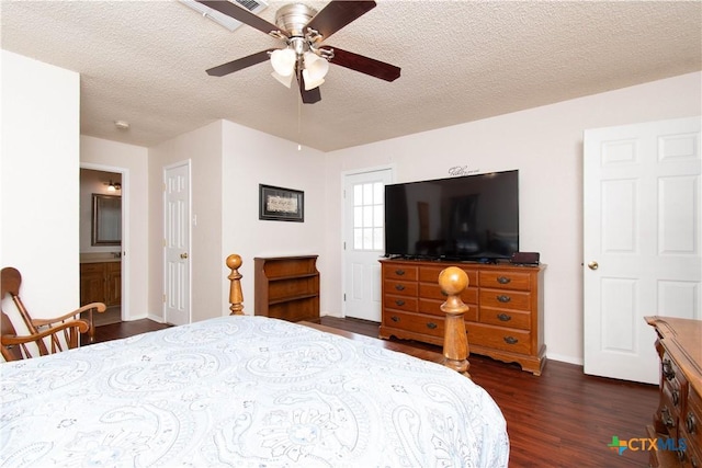 bedroom with ceiling fan, baseboards, dark wood finished floors, and a textured ceiling