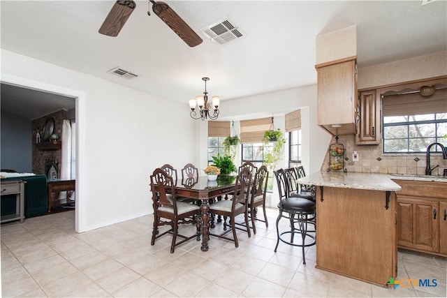 dining space featuring baseboards, visible vents, and a healthy amount of sunlight