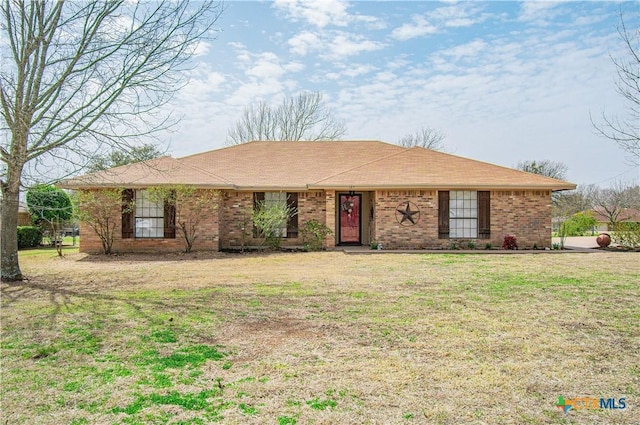 single story home with brick siding and a front yard