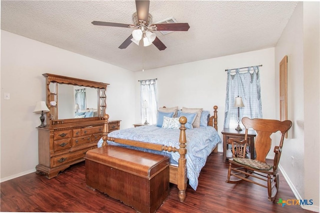 bedroom with ceiling fan, a textured ceiling, baseboards, and dark wood-type flooring