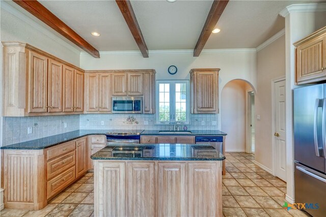 1041 Clarence Rd, Temple, TX 76501 - kitchen with light brown cabinetry, a sink, arched walkways, beam ceiling, and appliances with stainless steel finishes