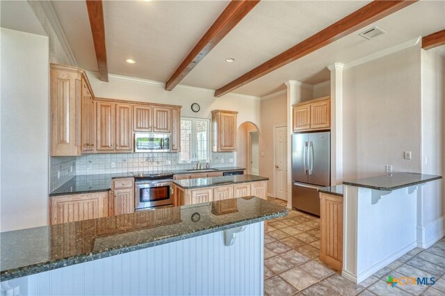 1041 Clarence Rd, Temple, TX 76501 - kitchen featuring backsplash, visible vents, beam ceiling, a peninsula, and appliances with stainless steel finishes