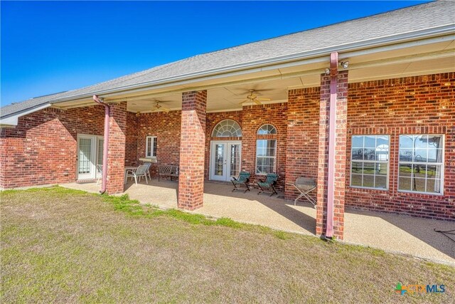 1041 Clarence Rd, Temple, TX 76501 - rear view of property with a patio area, brick siding, a ceiling fan, and a yard