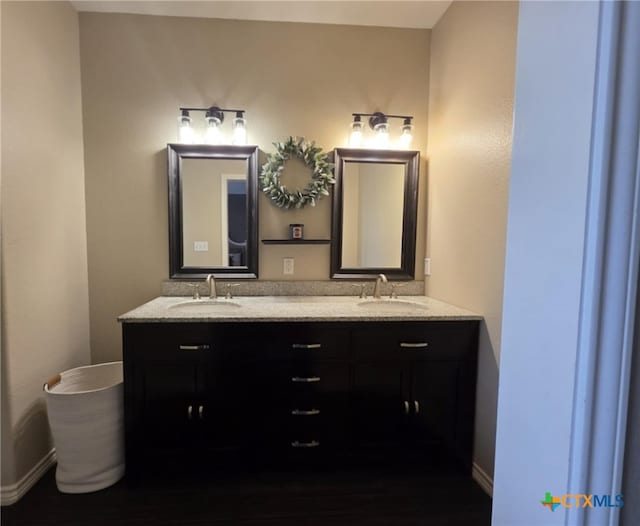 102 Lexington Ln, Victoria, TX 77901 - full bath with double vanity, baseboards, and wood finished floors