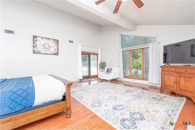 bedroom featuring ceiling fan, light wood-type flooring, lofted ceiling with beams, and access to outside