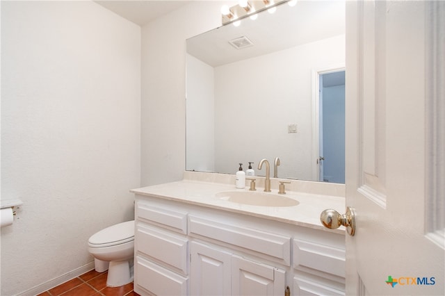 bathroom with vanity, tile patterned floors, and toilet