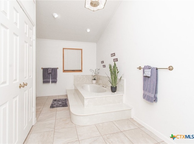 bathroom featuring lofted ceiling, tile patterned floors, and a bath