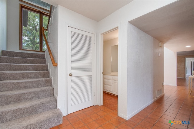 stairs with tile patterned flooring