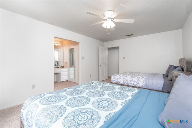 carpeted bedroom featuring a textured ceiling, ceiling fan, and ensuite bathroom