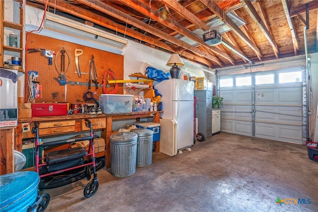 808 E Randall St, Beeville, TX 78102 - garage with freestanding refrigerator, a garage door opener, and a workshop area