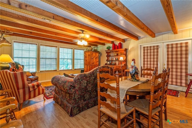 808 E Randall St, Beeville, TX 78102 - dining room with beam ceiling, wood finished floors, a ceiling fan, french doors, and wood walls