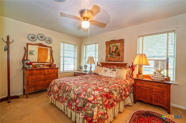808 E Randall St, Beeville, TX 78102 - bedroom with multiple windows, light colored carpet, and ceiling fan