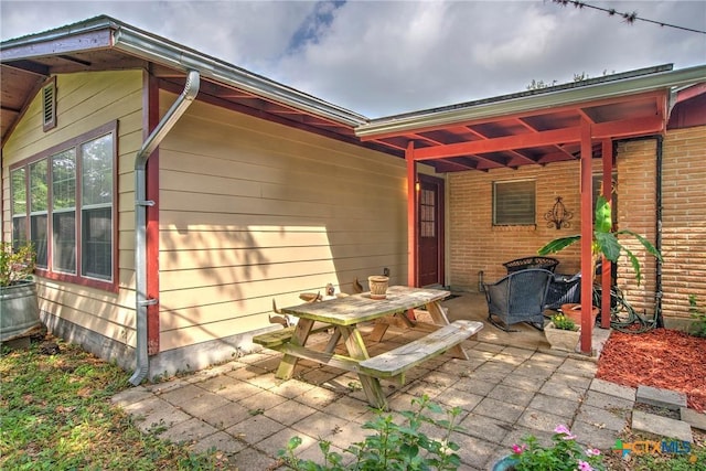 808 E Randall St, Beeville, TX 78102 - view of exterior entry with a patio area and brick siding