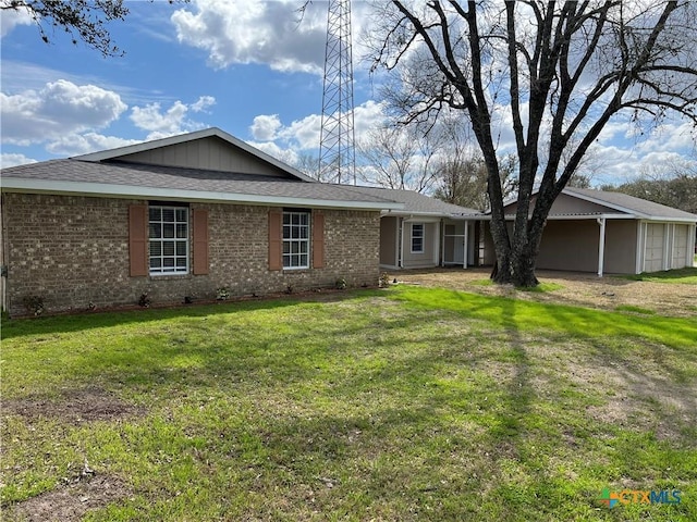 ranch-style house with brick siding and a front lawn