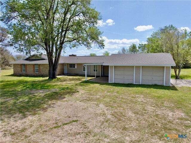 single story home featuring a front lawn and an attached garage