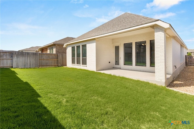 636 Vireos St, New Braunfels, TX 78132 - rear view of property featuring brick siding, a fenced backyard, a patio area, and a shingled roof