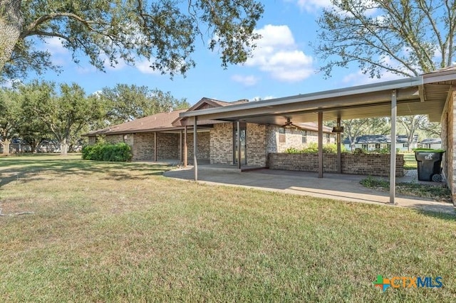 exterior space with ceiling fan and a patio area