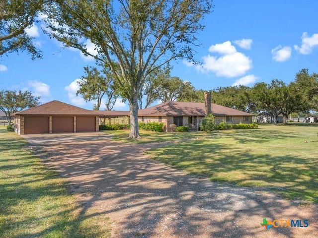 single story home with a garage and a front lawn