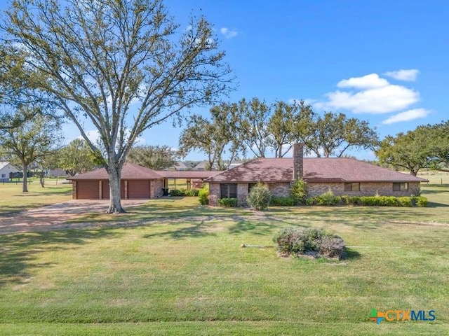 ranch-style house featuring a garage and a front lawn