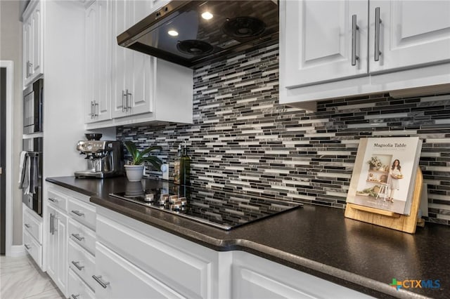 kitchen featuring dark countertops, range hood, black electric stovetop, and white cabinets